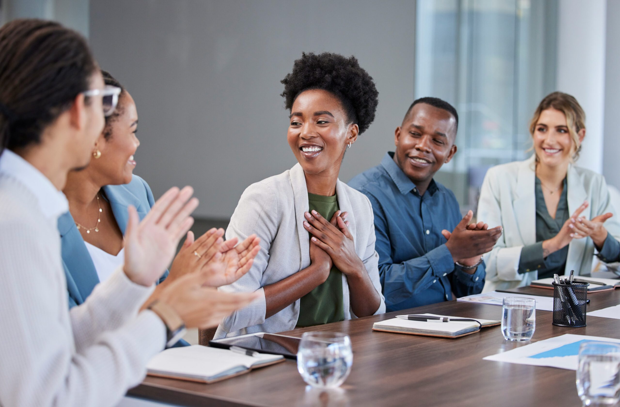 Black woman, success or applause of business people in a meeting for winner of sales target or goals. Support, thank you or happy African worker with pride or smile after job promotion or achievement.
